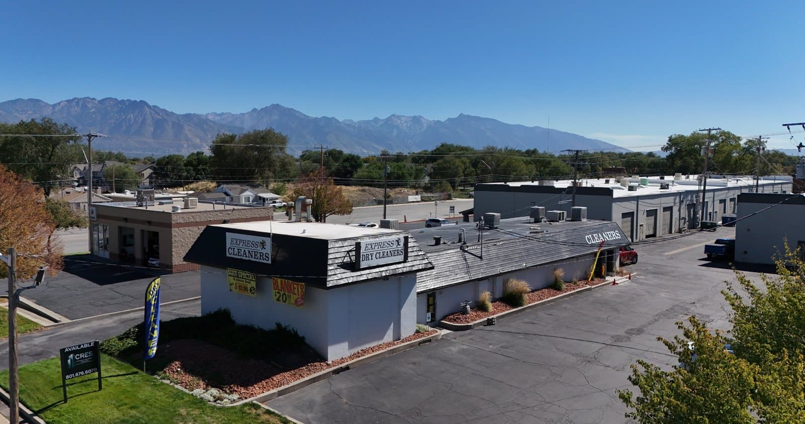 Aerial of the drive-thru retail building for sale at 2324 S Redwood Rd, West Valley City, with the Wasatch range behind