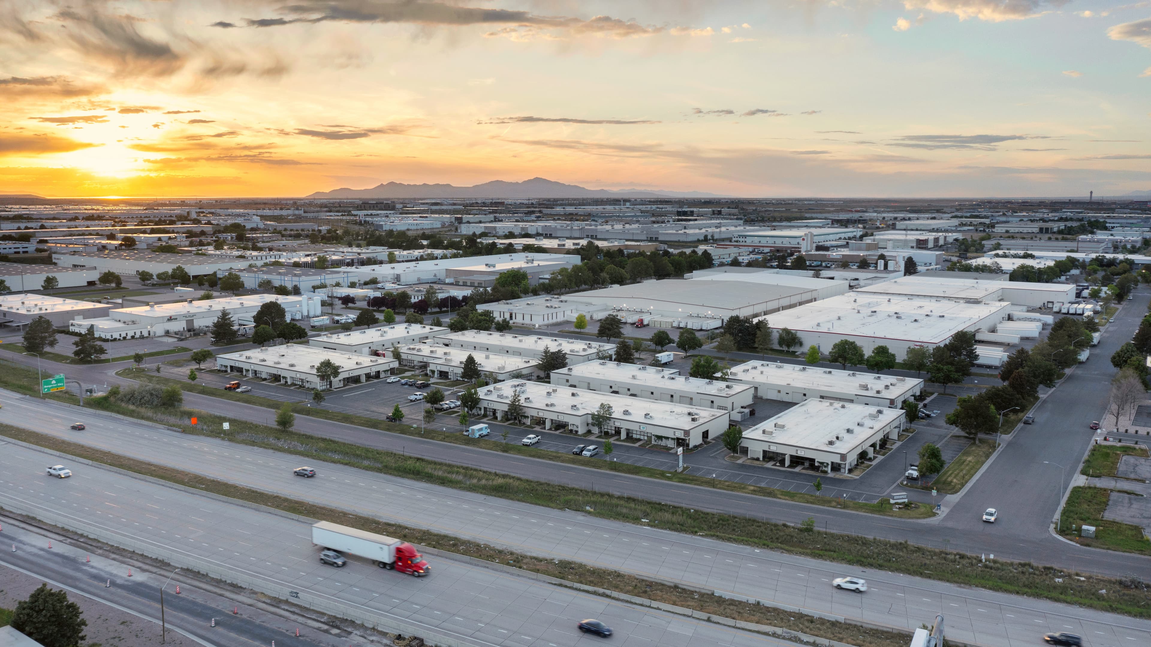 Sunset aerial drone view over Broadbent Business Park and the Salt Lake Valley industrial corridor